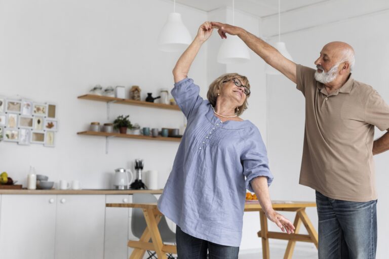 older man and woman dancing in the kitchen